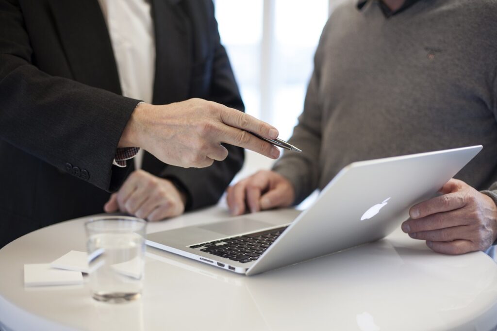 A meeting between two office workers as part of an implementation consulting process